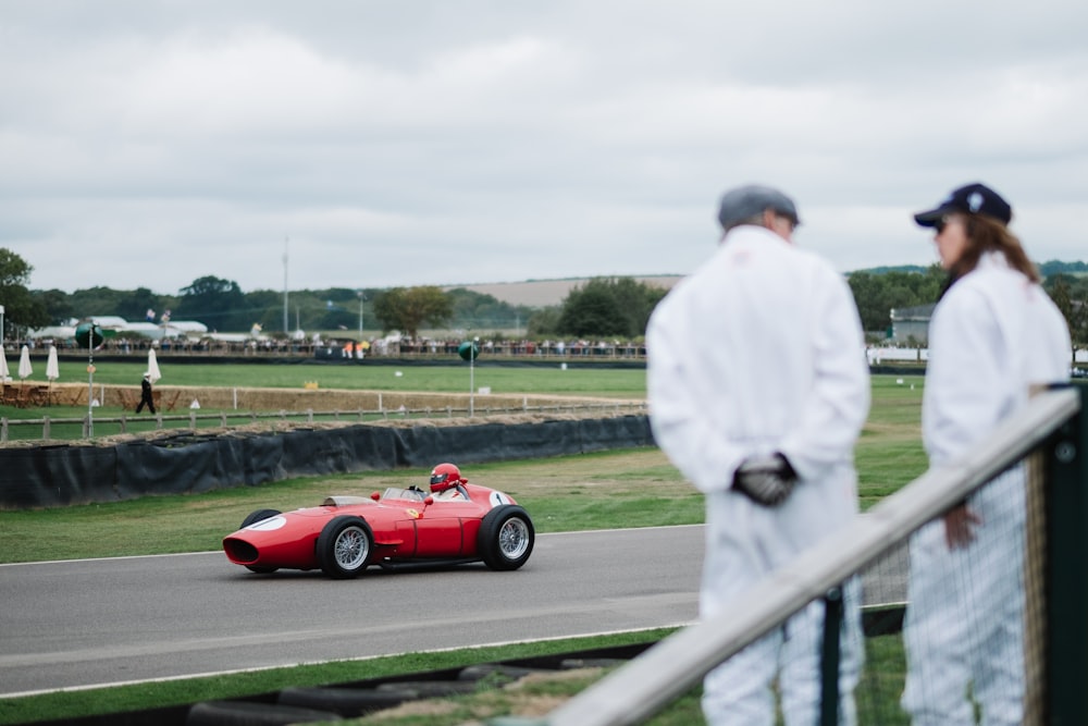 person riding racing go-kart between grass field