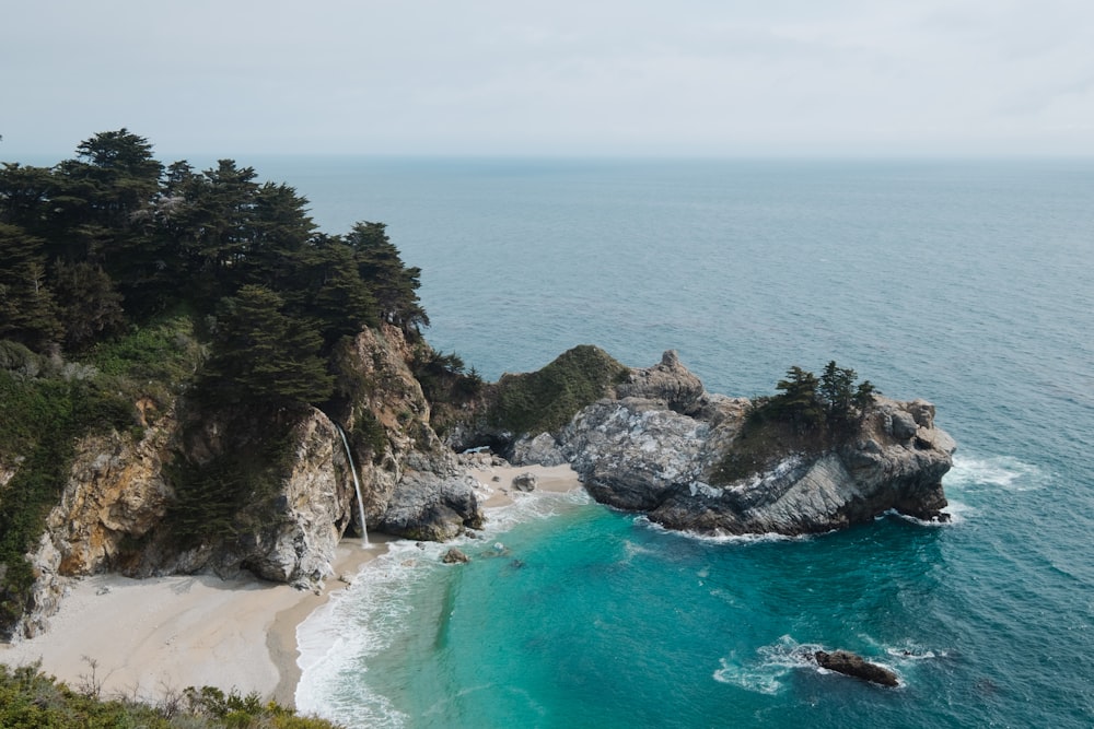 gray and brown rocky cliff facing body of water