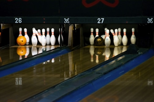 Interior shot showing classic wooden lanes and retro bowling balls.