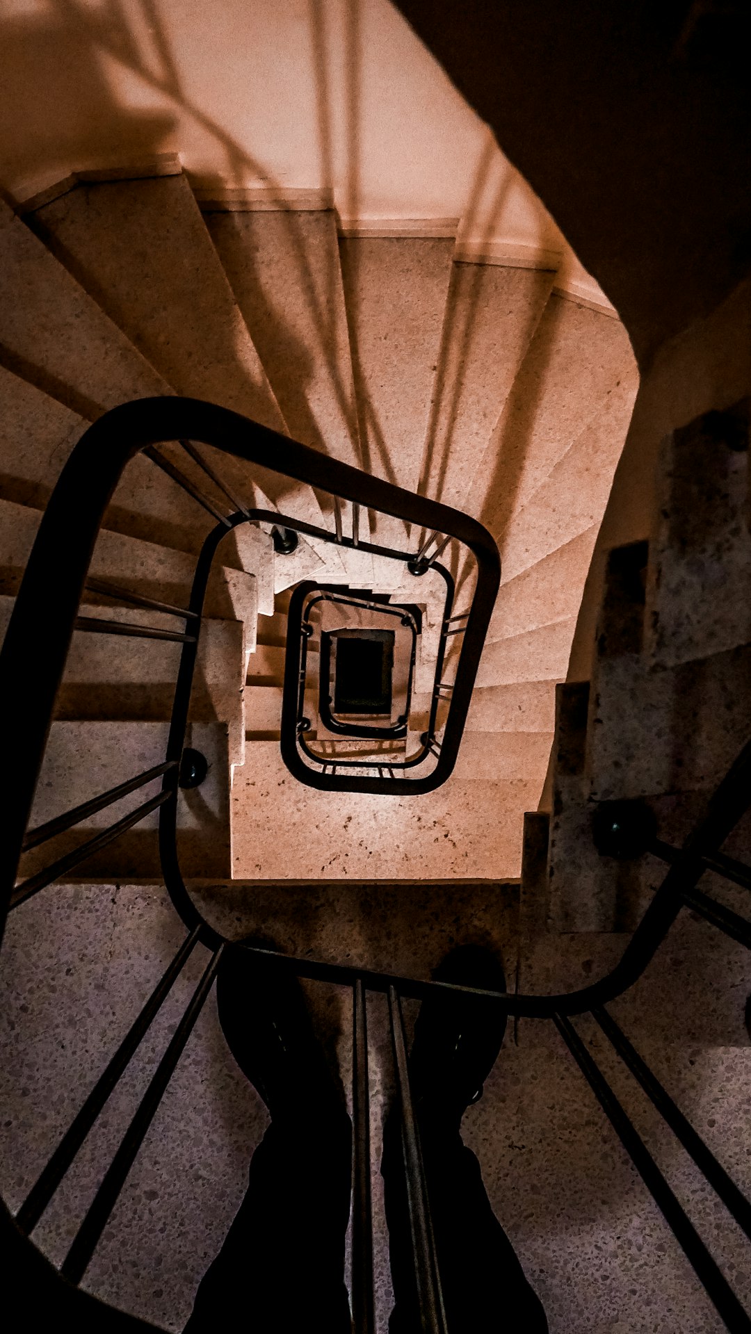 black metal spiral staircase in grayscale photography