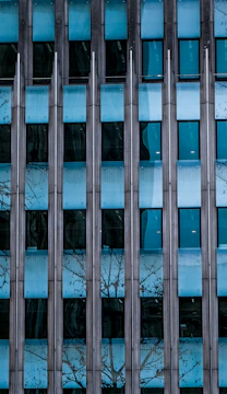 A modern building facade featuring large aluminum-framed windows.