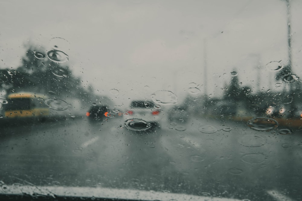 a view of a rainy street from inside a car