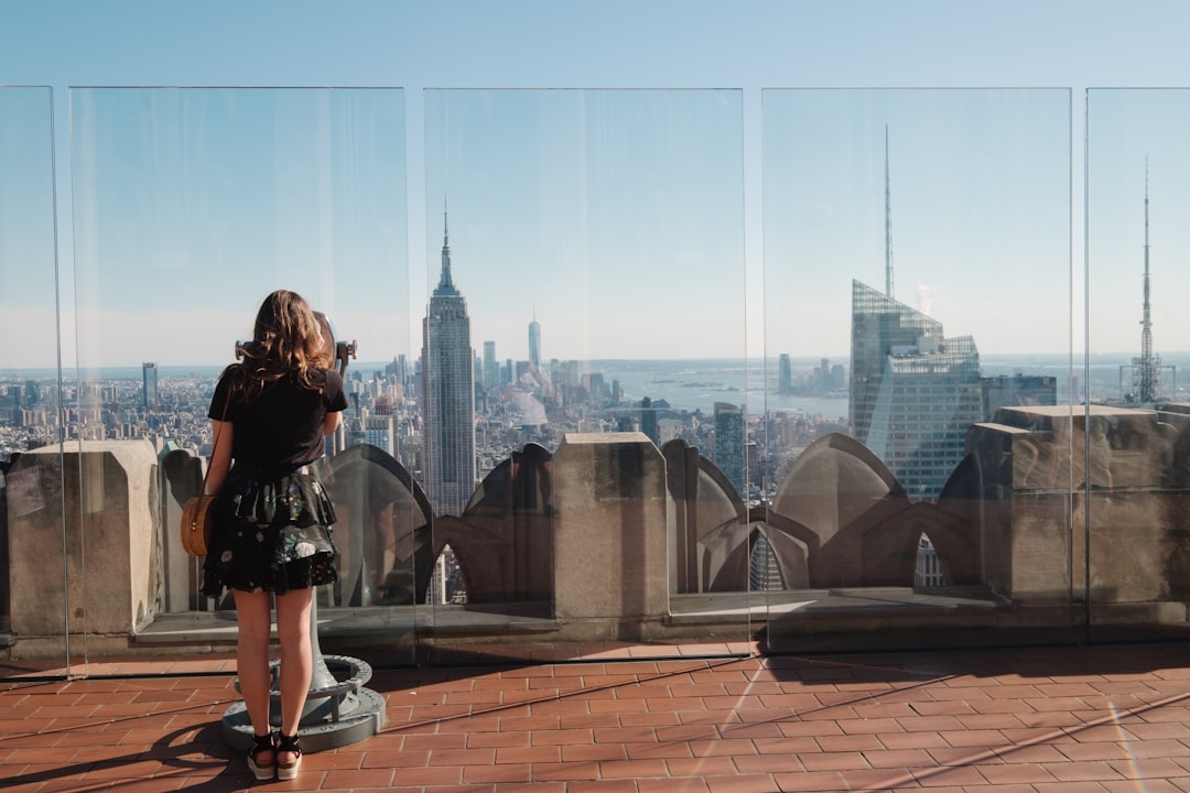 woman standing near glass wall