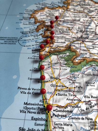 A detailed map featuring parts of Portugal and Spain with several red pushpins placed along a route that appears to be marking a path or itinerary. The map includes various towns, cities, and geographical features, and displays the northern coast of Portugal, including places like Braga, Porto, and Póvoa de Varzim.