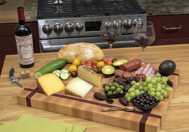 Warm kitchen scene with Spanish olive oil, gourmet preserves, and spices artfully arranged on a rustic wooden table.