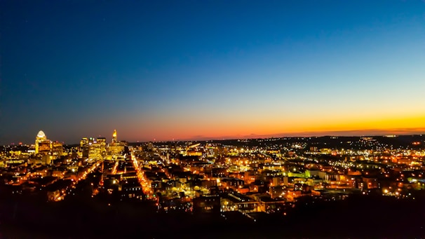 A city skyline at dusk with illuminated buildings powered by clean energy.