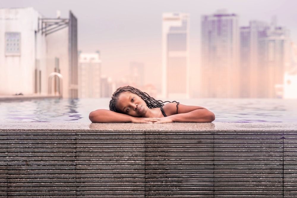 woman on pool under gray sky