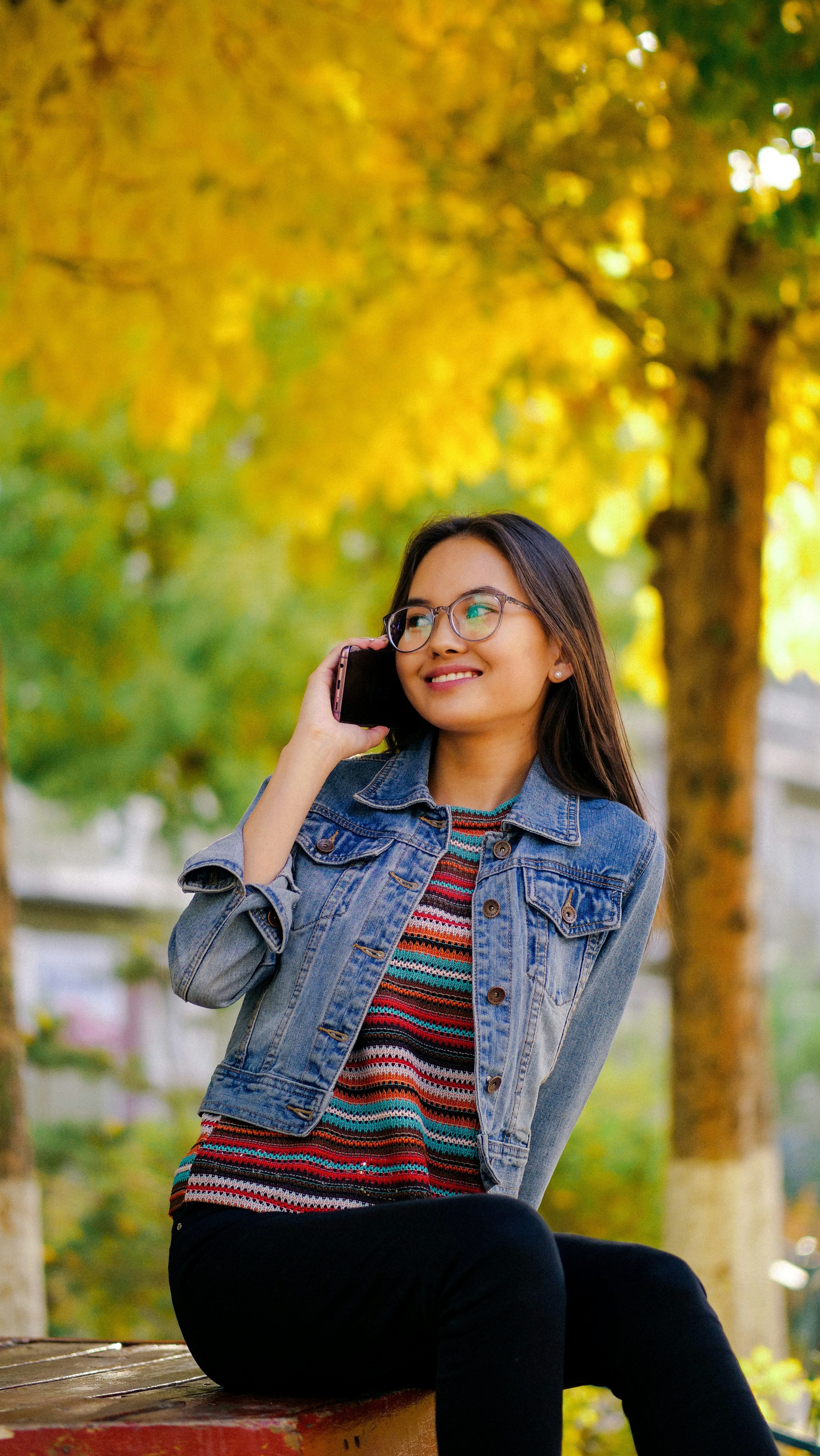 shallow focus photo of woman in blue denim button-up jacket