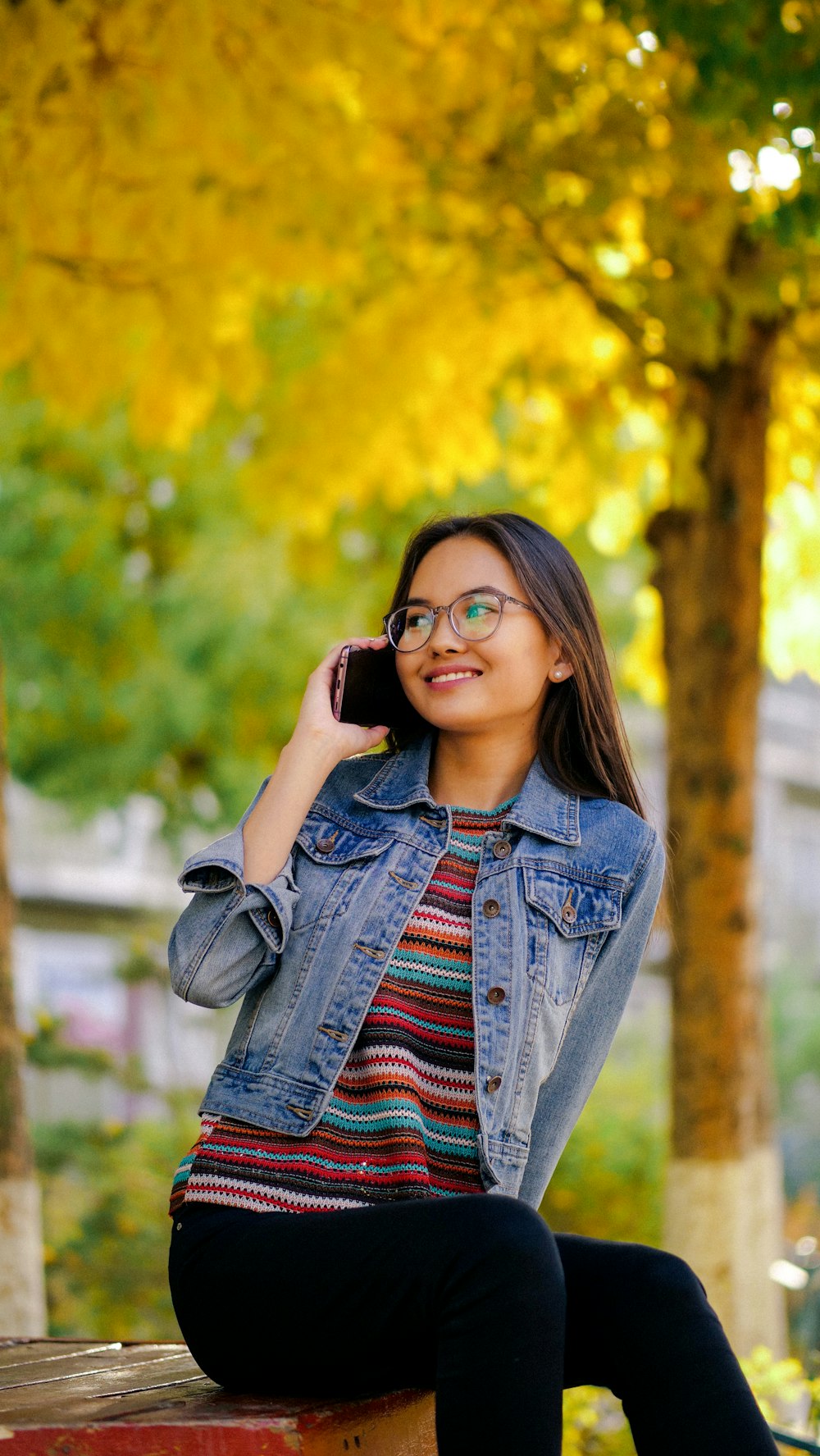 shallow focus photo of woman in blue denim button-up jacket