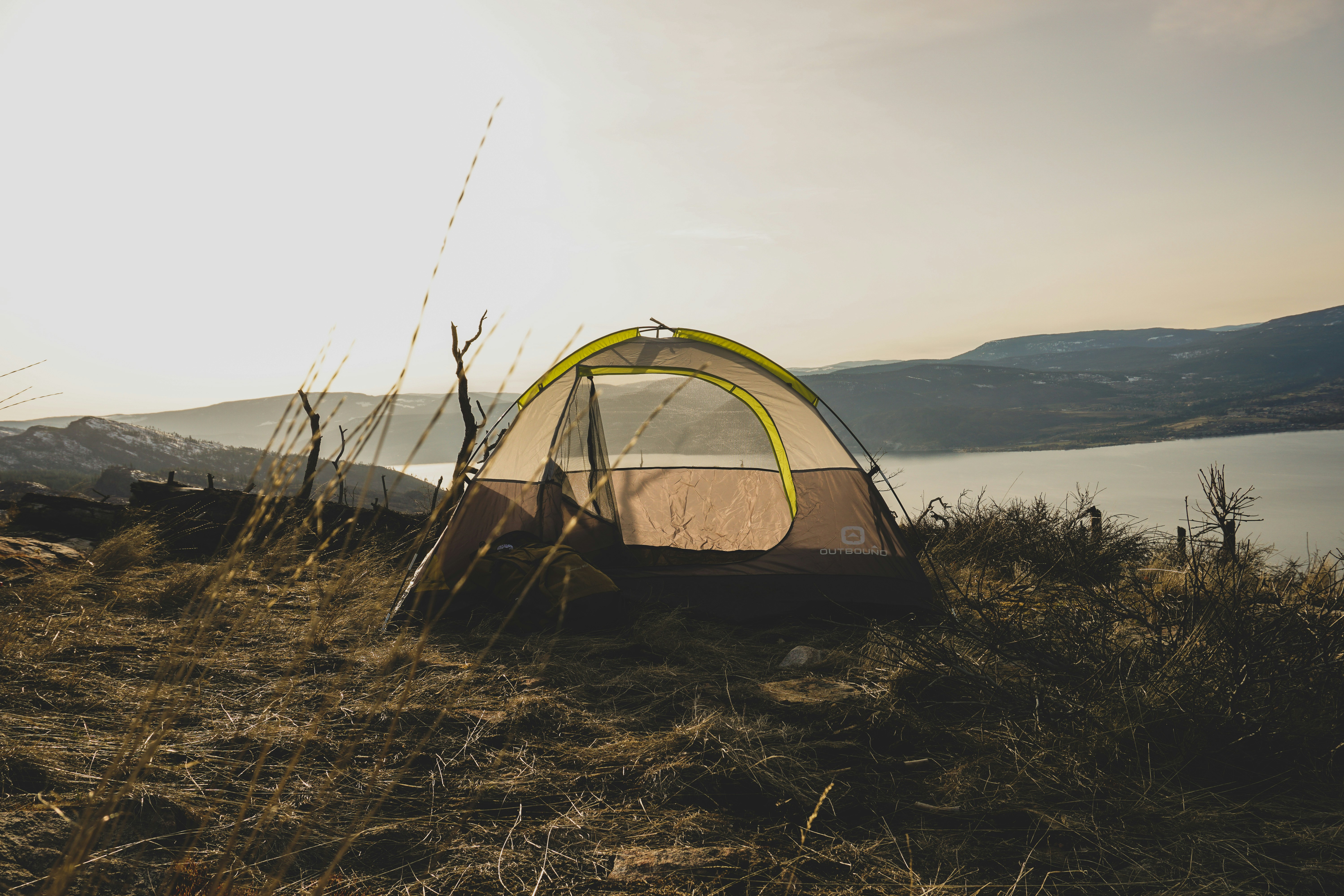 brown and gray tent near body of water during daytime