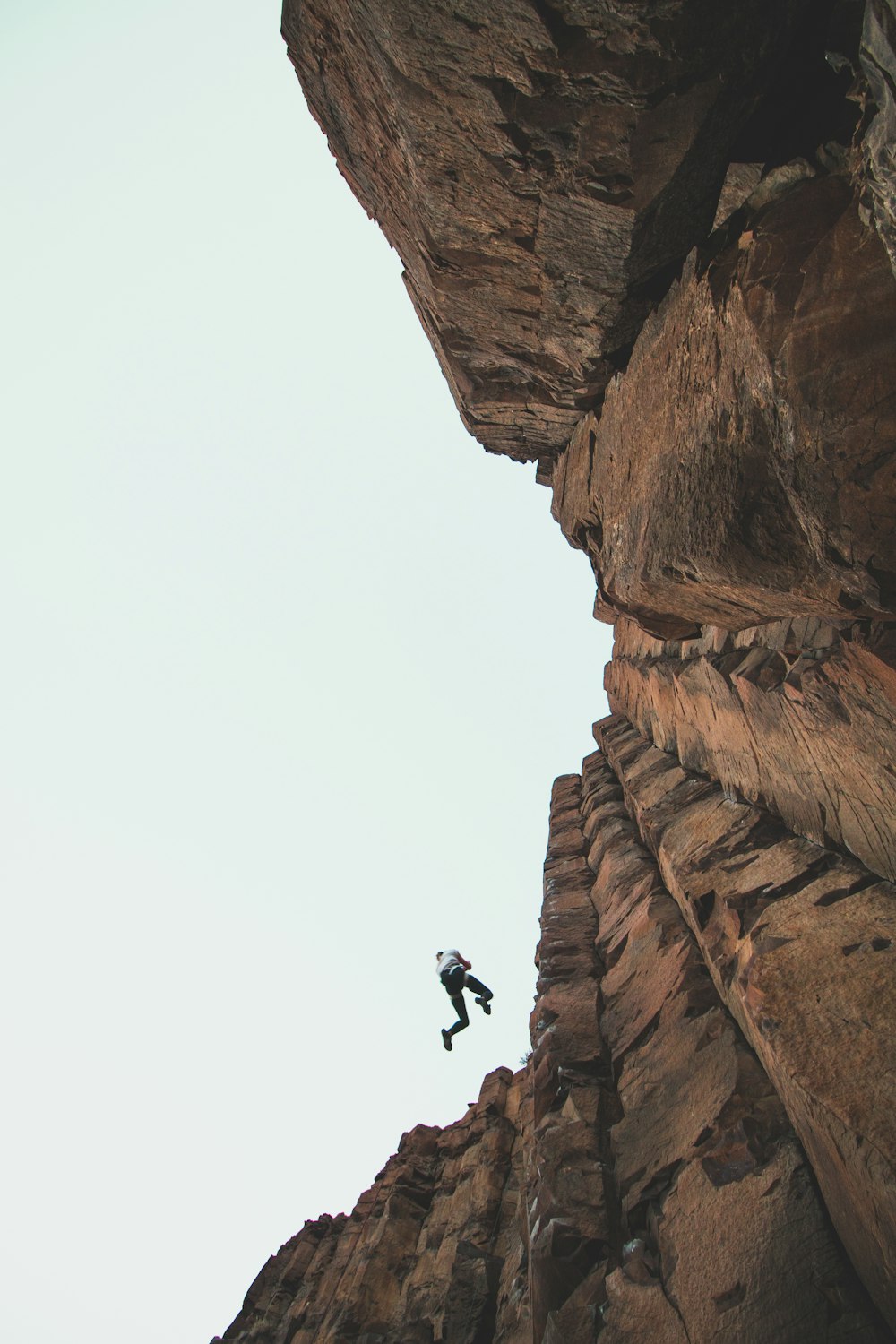 person climbing mountain during daytime