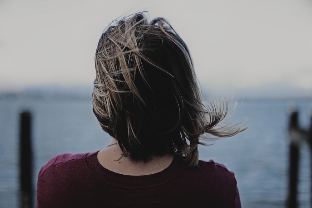 woman in maroon tops on selective focus photography