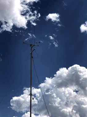 A modern weather station with digital screens showing real-time weather data.