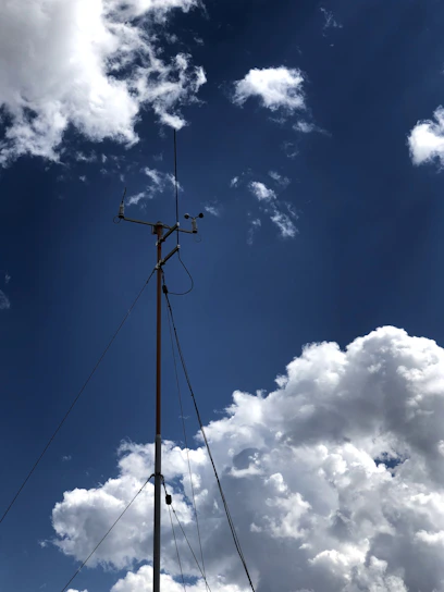 A modern weather station with digital screens showing real-time weather data.