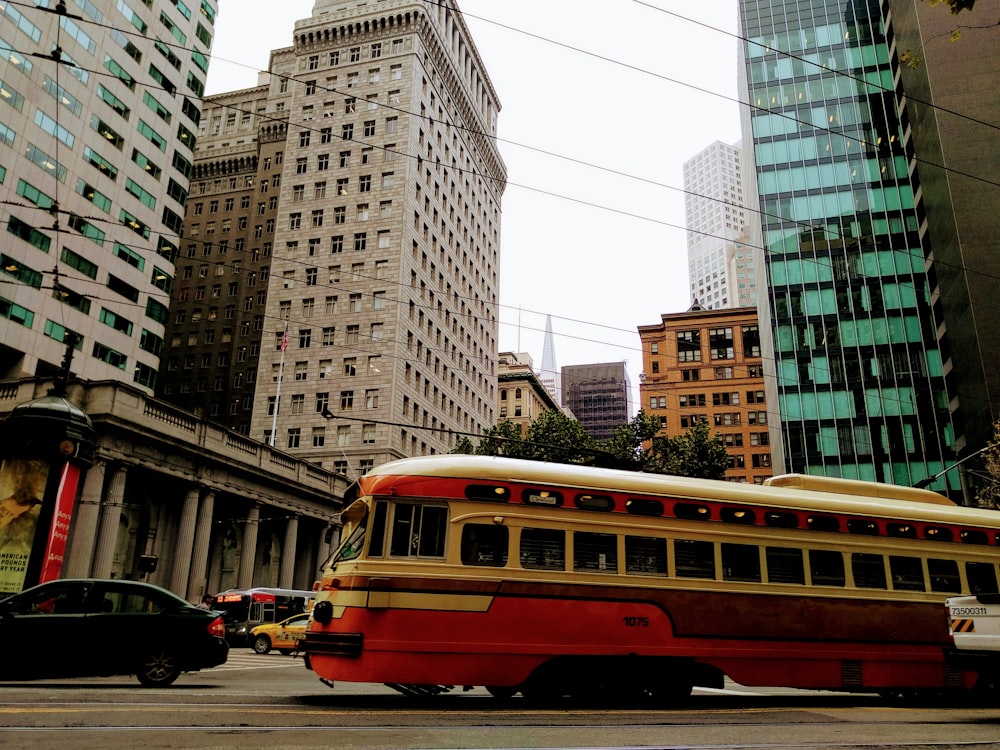 selective focus photography of red and white bus on road during daytime