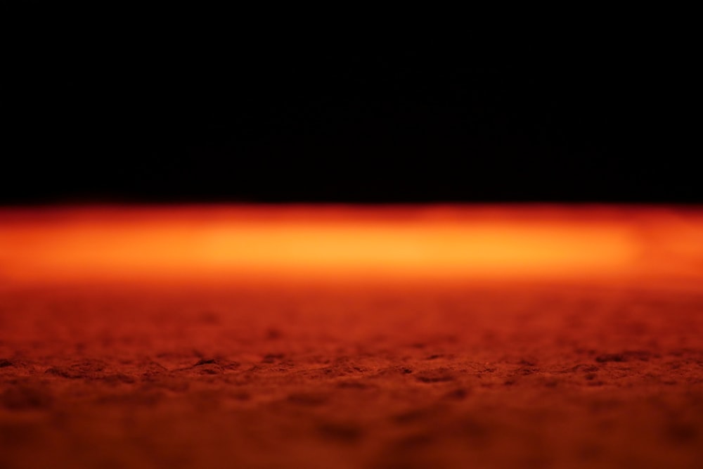a close up of a red object with a black background