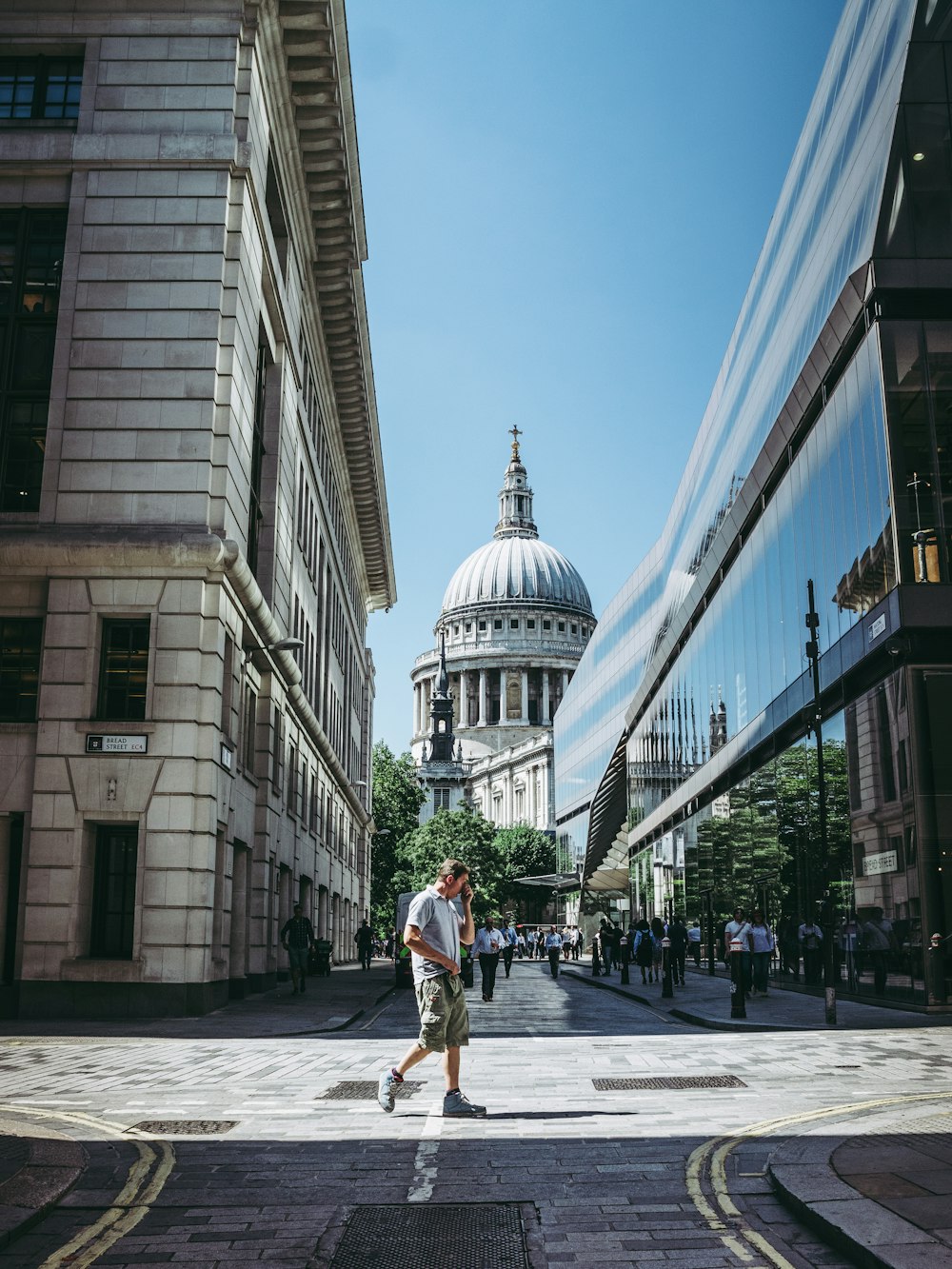 people walking near concrete building under blue skies