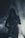 A silhouette of a person playing a saxophone, surrounded by fog or smoke. The lighting creates a dramatic and mysterious atmosphere with a focus on the saxophone.