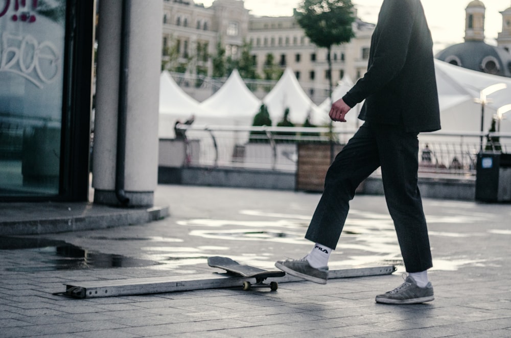 man stepping on skateboard