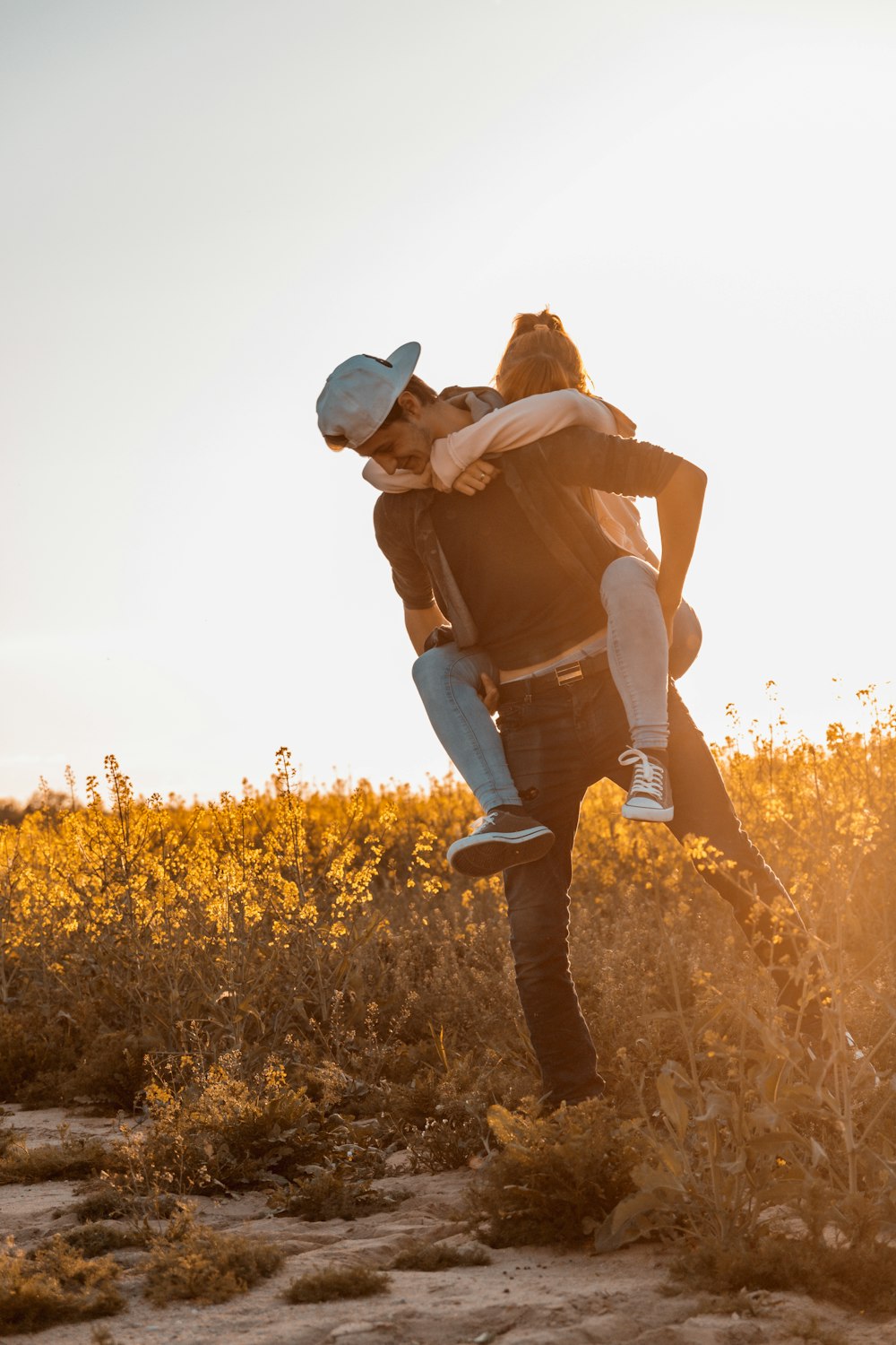 woman doing piggy back ride on man