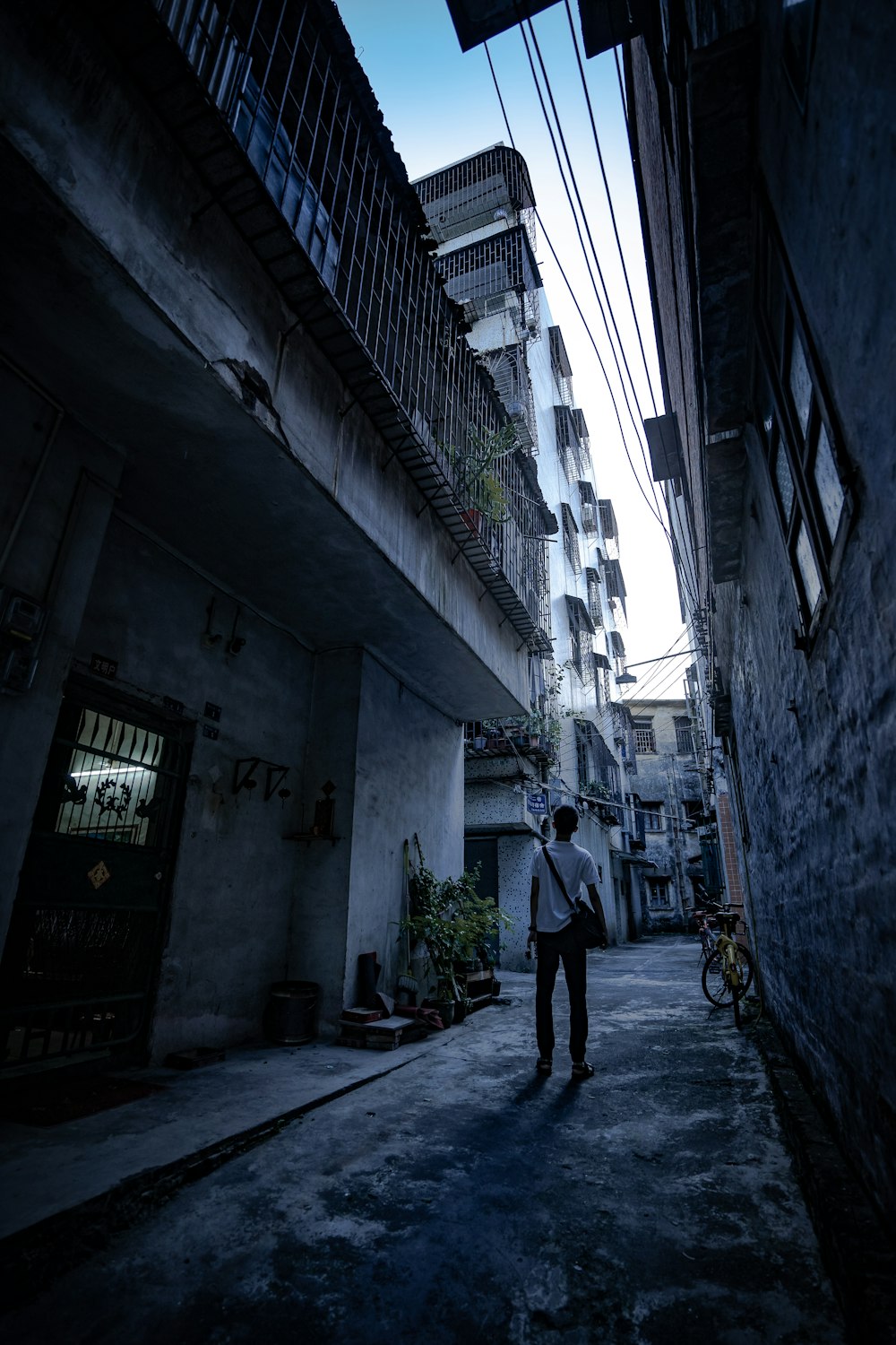 man walking in between buildings