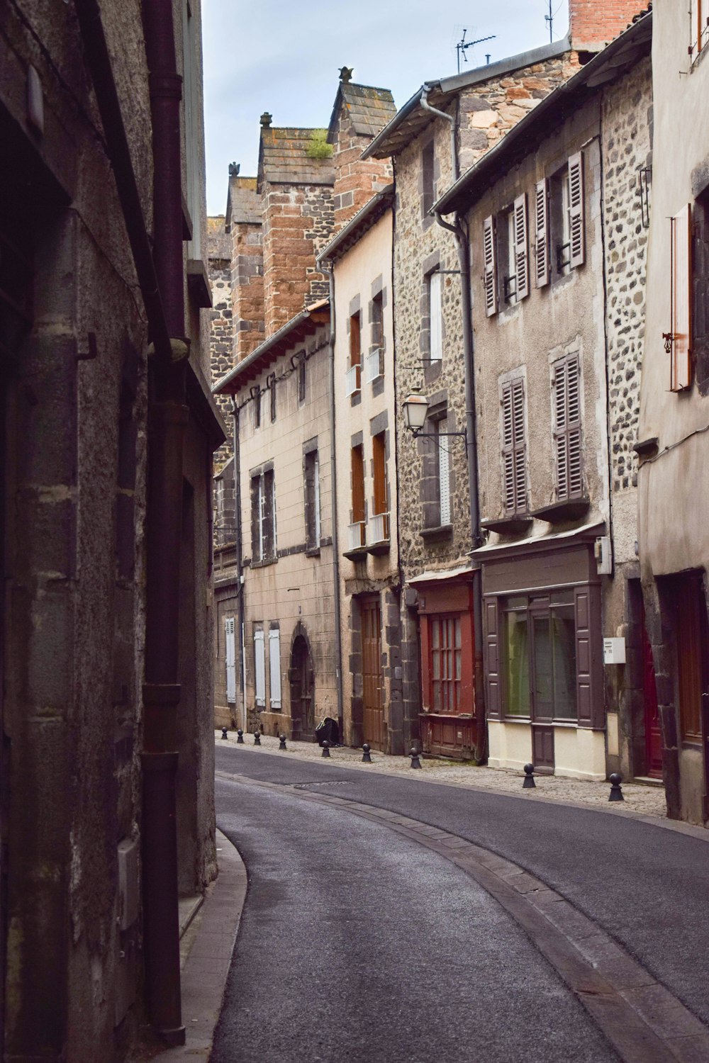 grey road near 3-storey buildings