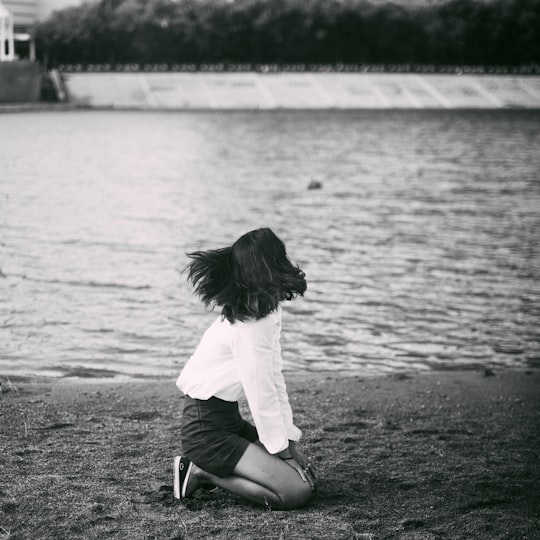 grayscale photography of woman beside body of water in Astana Kazakhstan