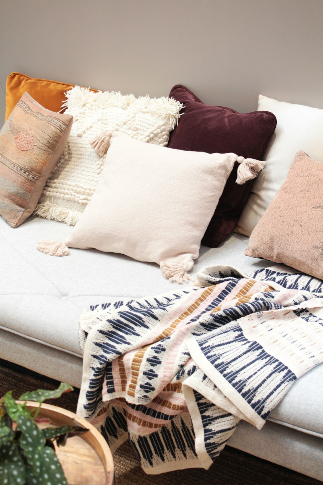  assorted throw pillows on gray couch blanket