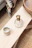 A close-up of a glossy resin tray with swirling blue and gold patterns on a wooden table.