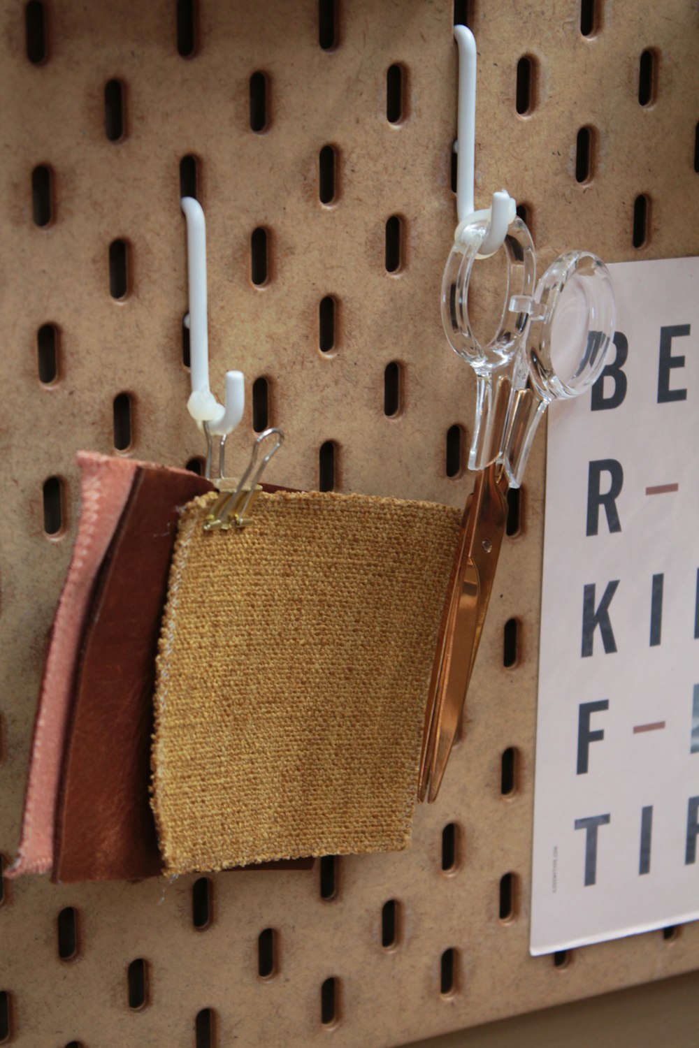 brown textiles hanging on a metal hook