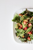 A colorful salad featuring fresh greens and gentle dressing.
