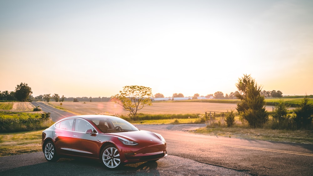 red sedan on road