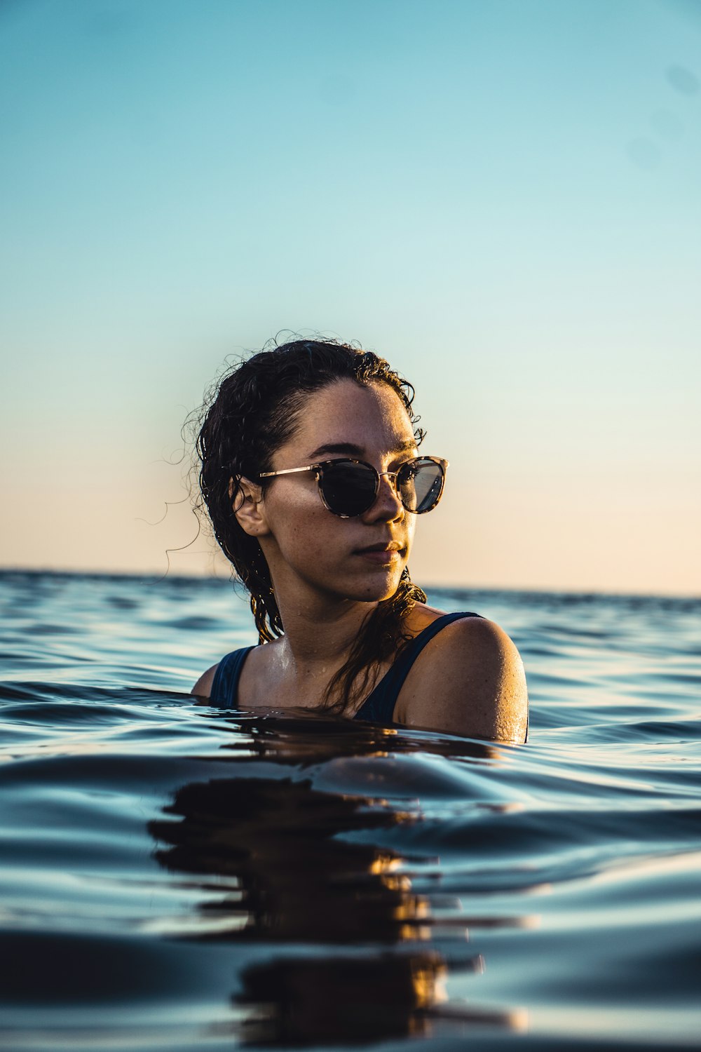 Mujer de pie en el cuerpo de agua durante el día