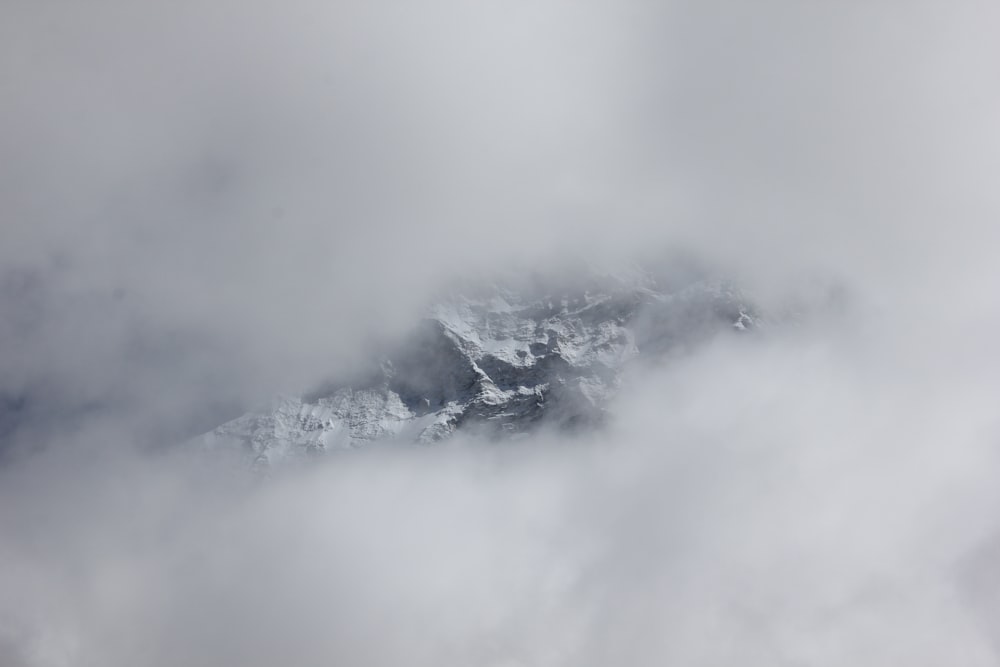 a view of a mountain through the clouds