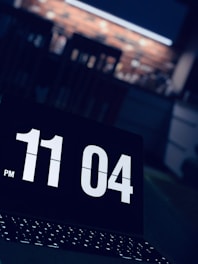 A clock showing late hours with a person manually sending emails.