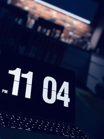A clock showing late hours with a person working late.