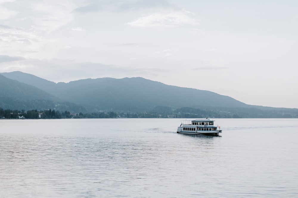 white boat surrounded by mountain