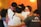 A group of people embracing each other closely in an emotional hug. Their expressions convey deep feelings, with some individuals having their eyes closed and holding tightly. The background is warm-toned, enhancing the heartfelt moment.