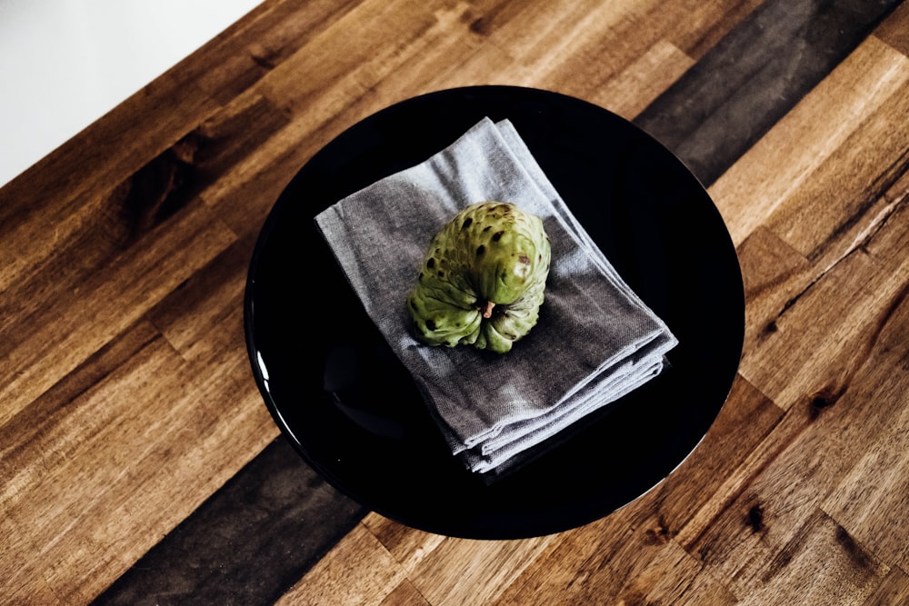 green fruit on round black plate