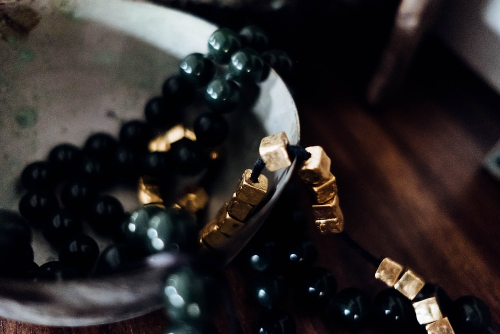 beaded black necklace on white surface