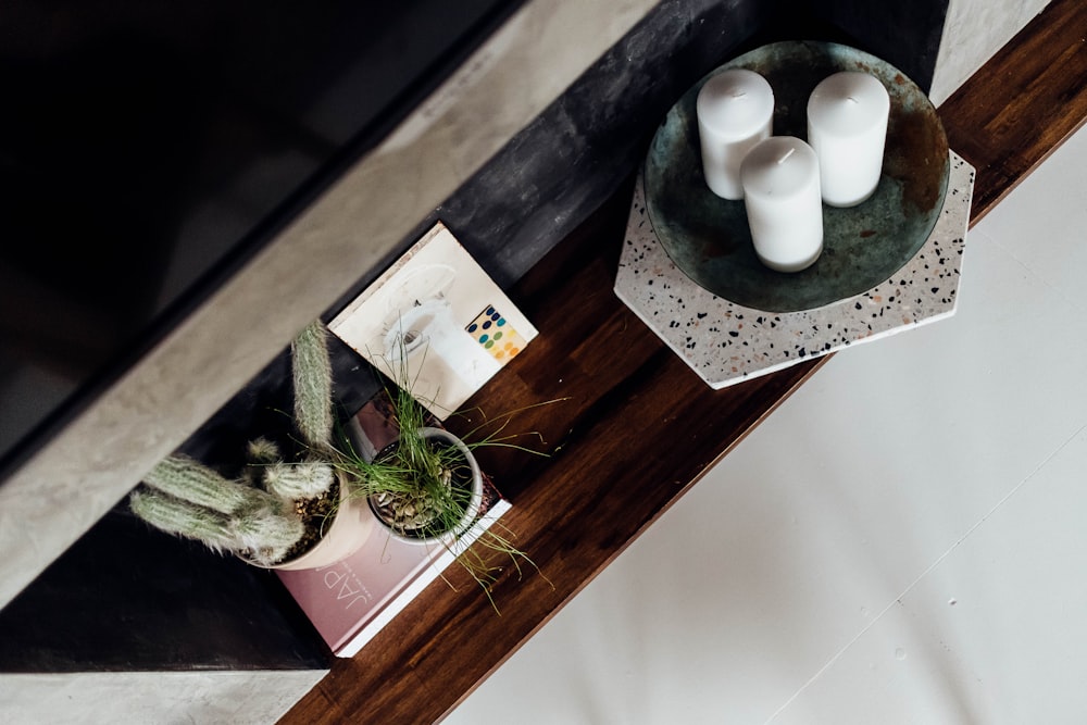 three white pillar candles in tray