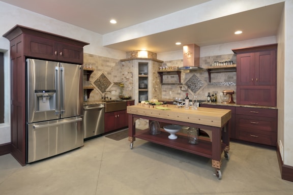 A cozy modern kitchen featuring a sleek refurbished side-by-side refrigerator with water and ice dispenser.