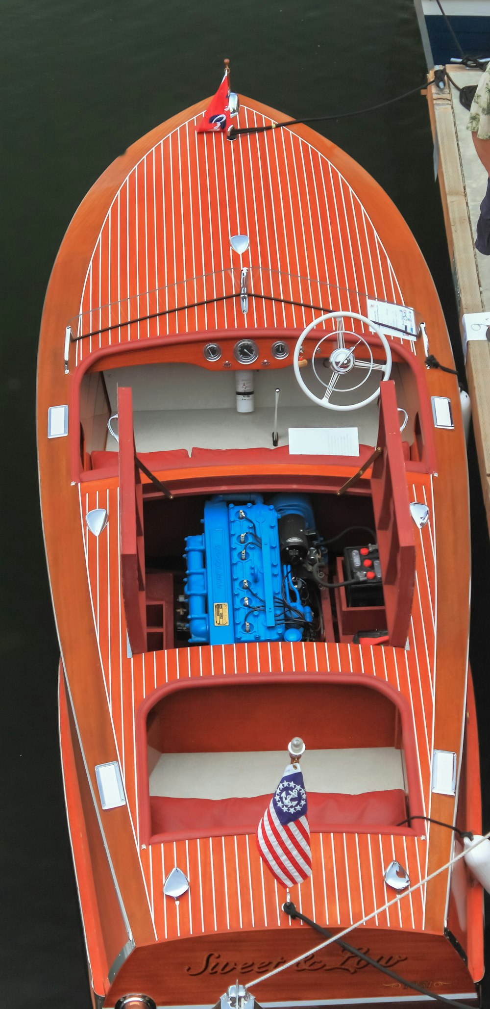 brown and white motorized boat near dock