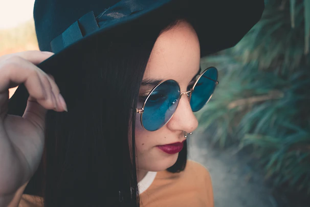 A stylish model wearing bold, expressive eyeglasses with talking eyes design outdoors