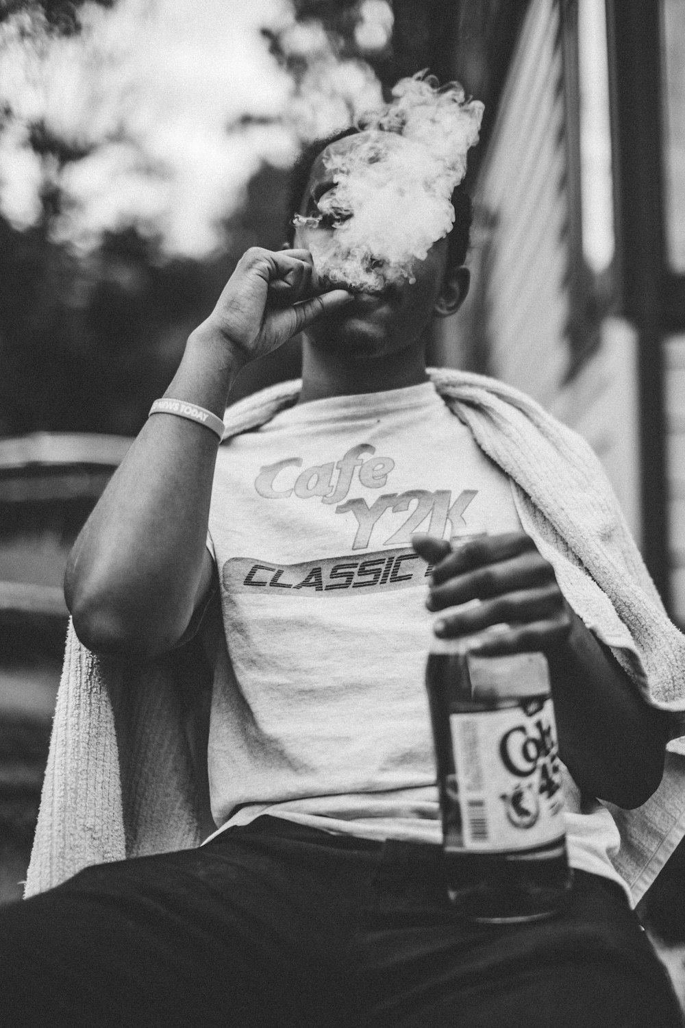 man wearing white shirt smoking