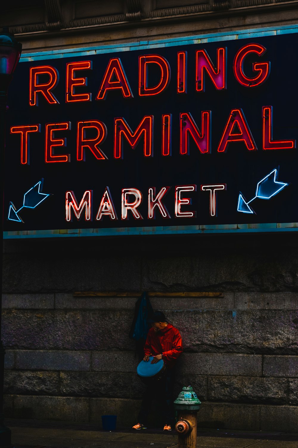 person standing near red and white reading terminal signage