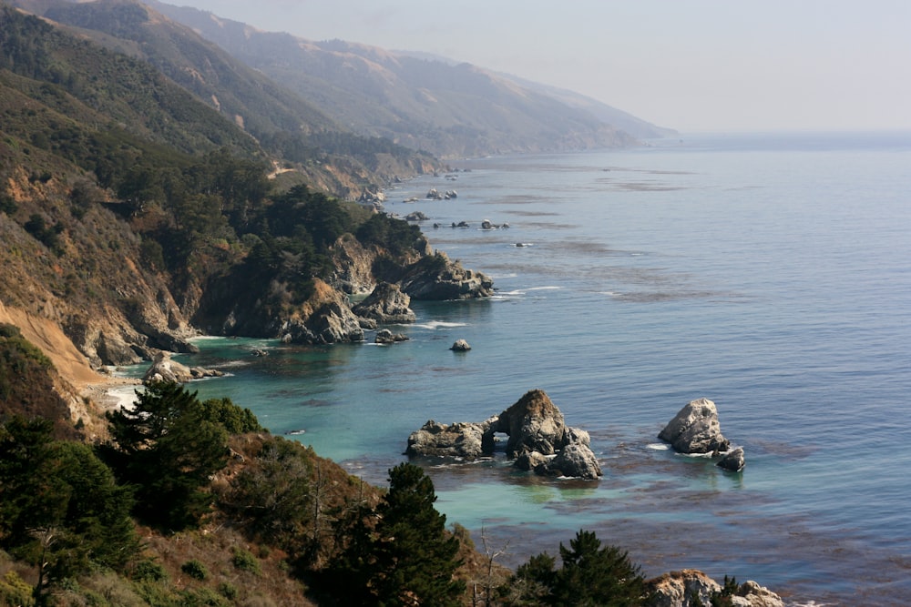 rock mountains near body of water