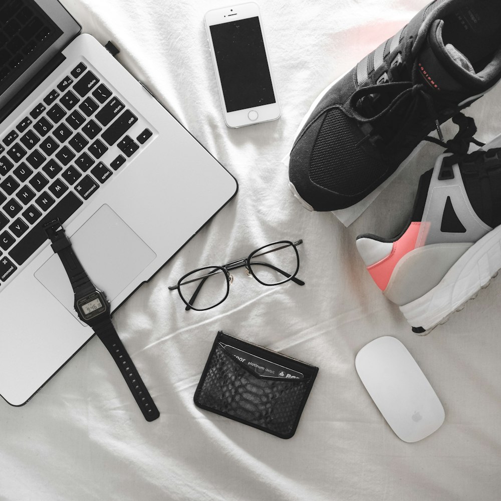 black framed eyeglasses surrounded with assorted-color items