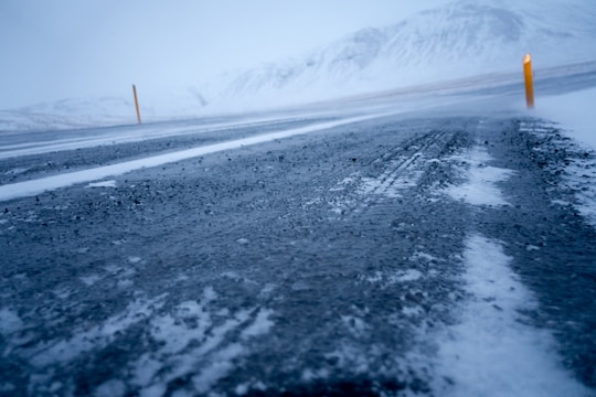 Snow covered icy road showing black ice driving conditions
