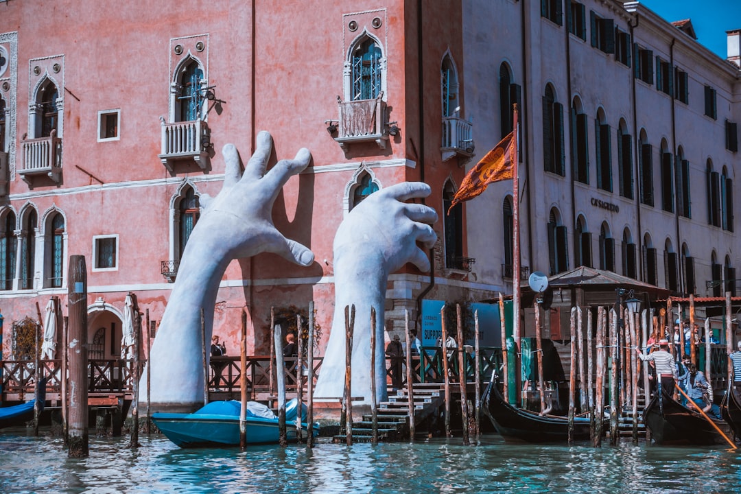 hand statue on body of water